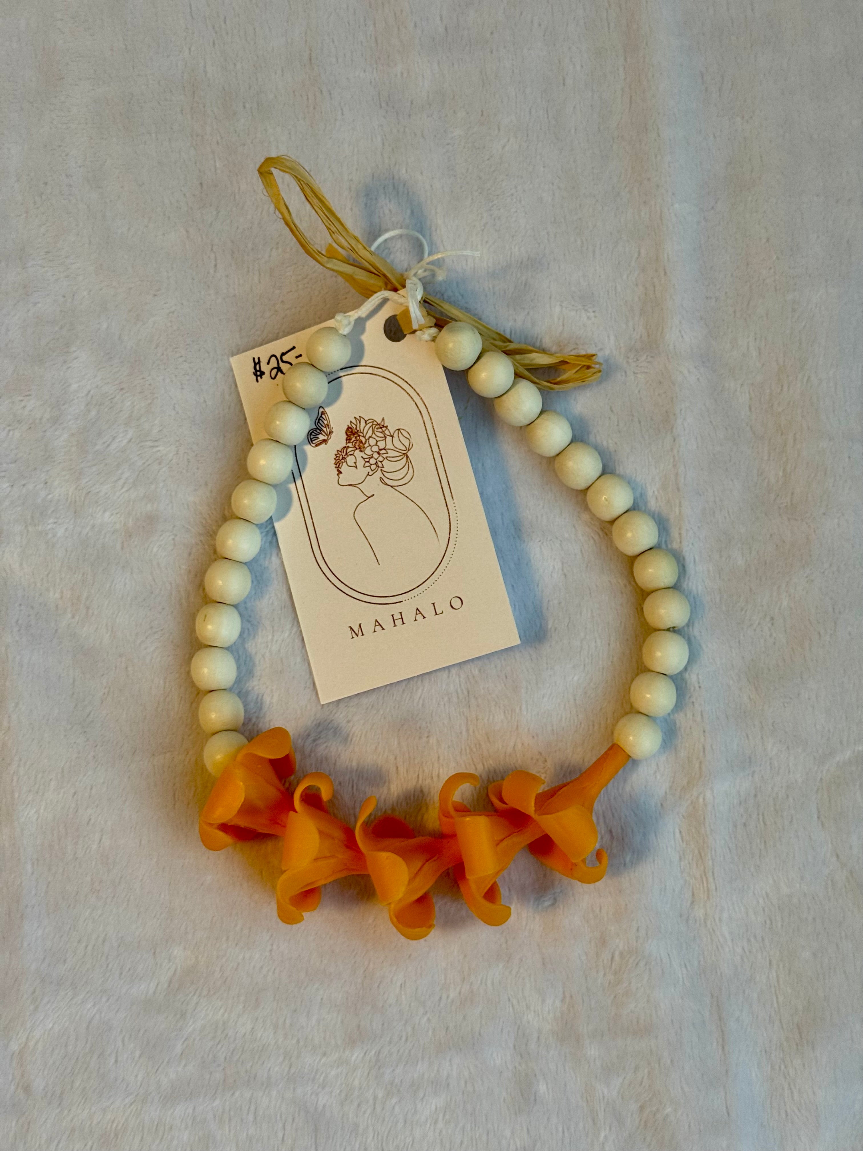 orange puakenikeni mirror lei for car
