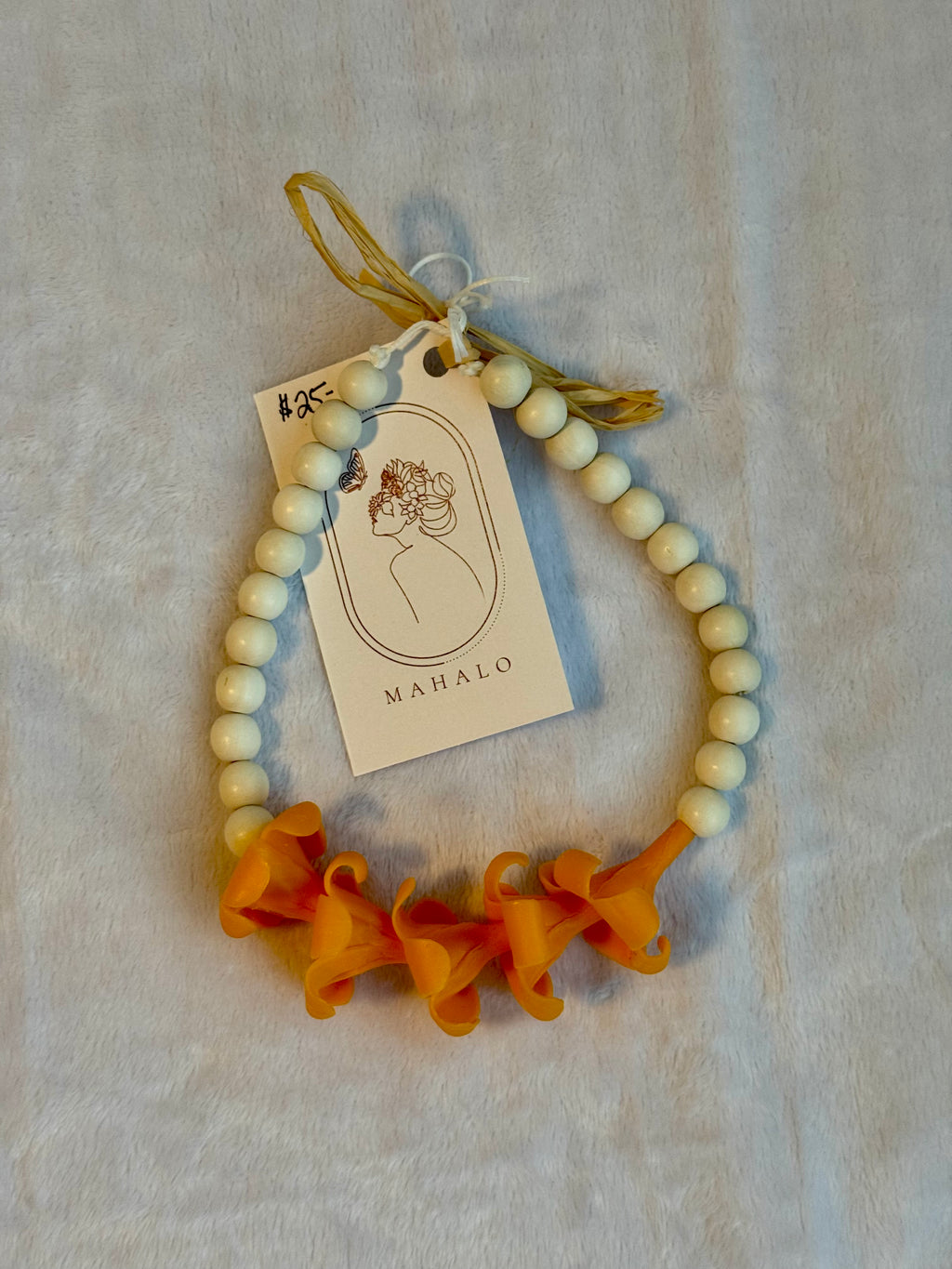 orange puakenikeni mirror lei for car